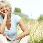 Mature woman sitting in countryside